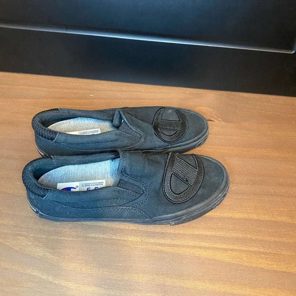 Champion black slip-ons size 5.5Y (kids size), size 7 in women’s